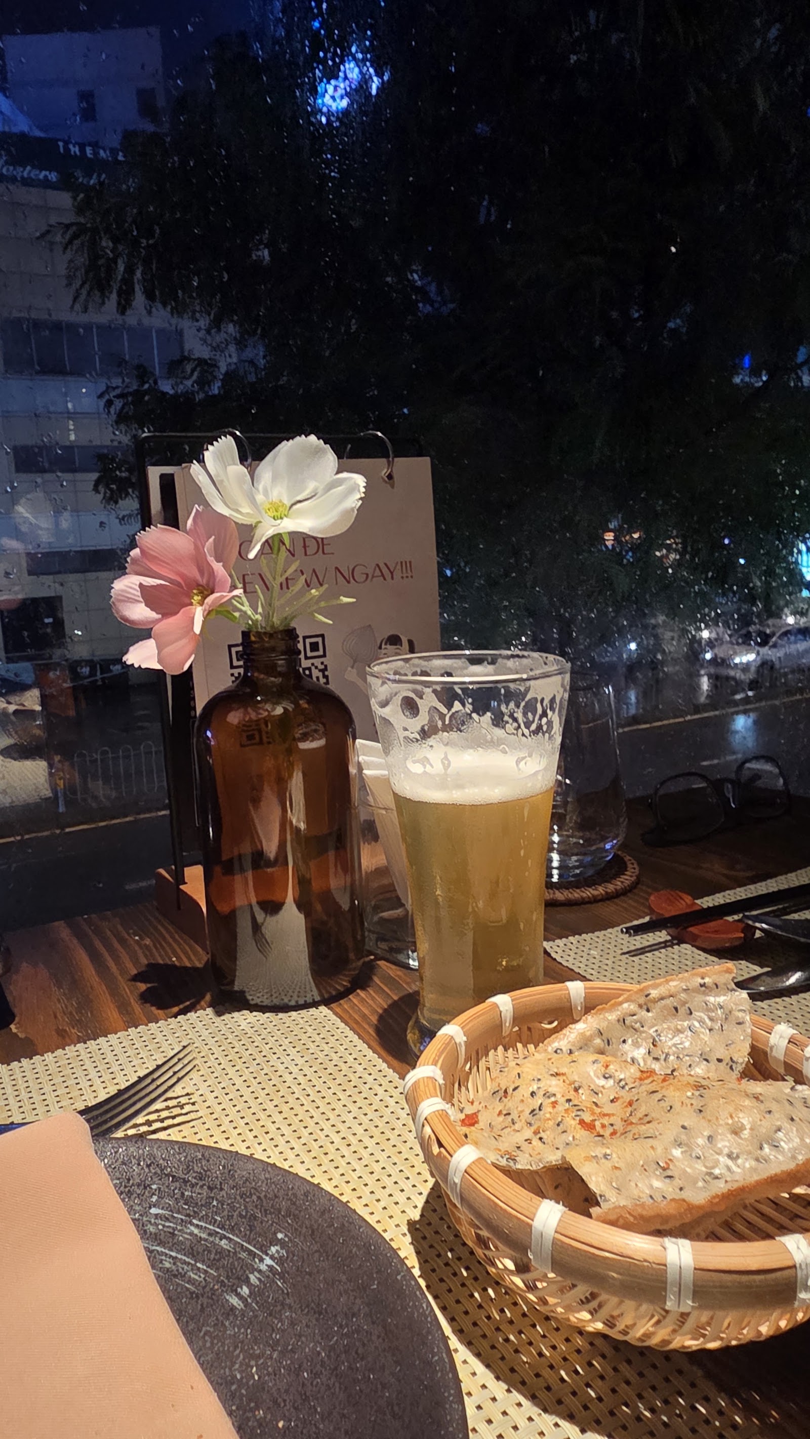 A night table at BỜM: beer, flowers and rice crackers