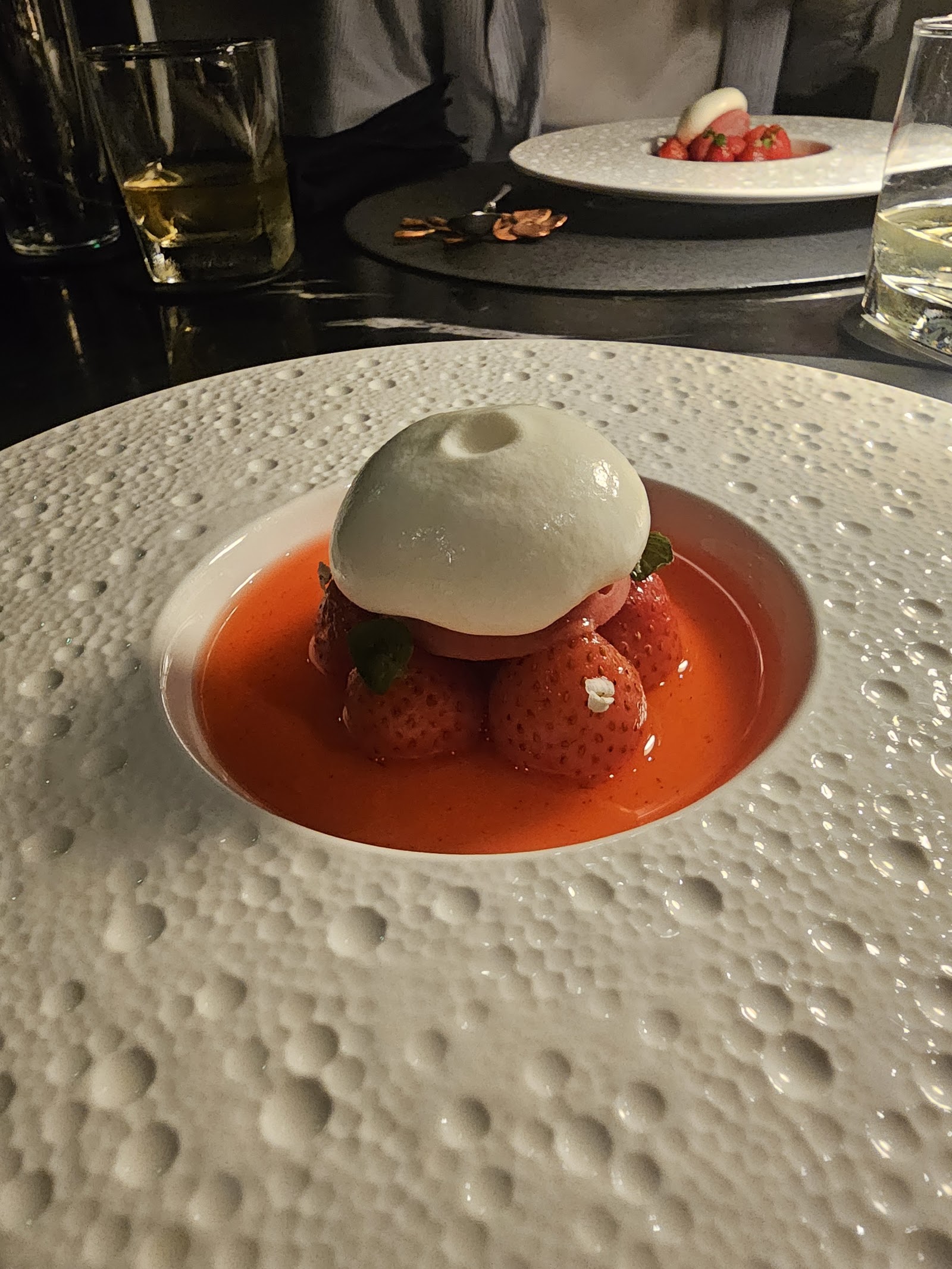 Strawberry dessert — fresh strawberries, red consommé, white dome