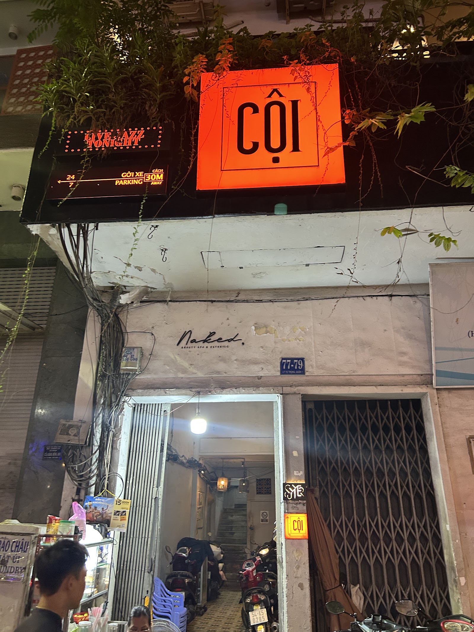 The glowing orange CỘI sign on the facade