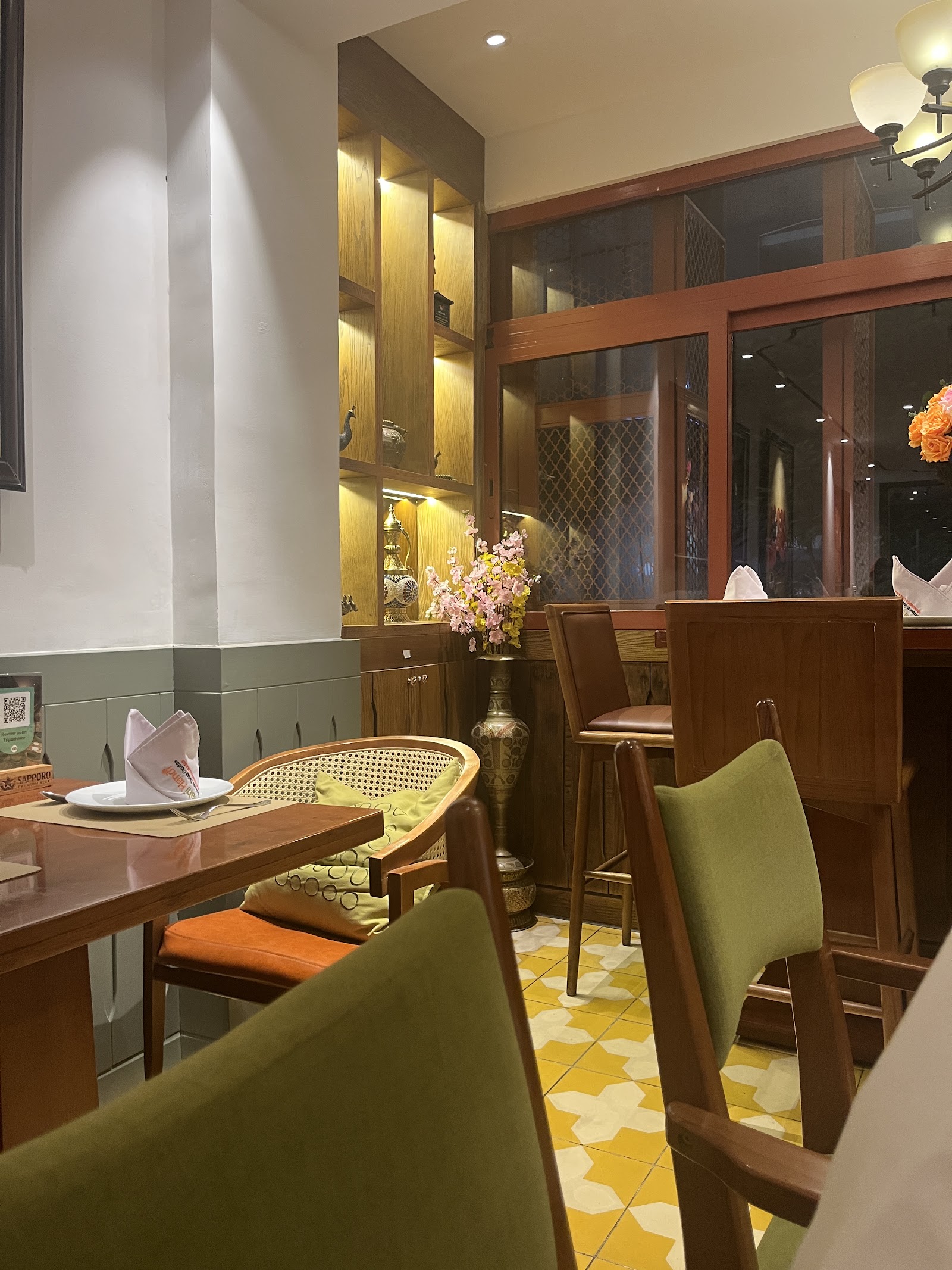 The warm wood room with lit Indian-brass display niches