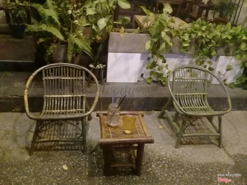 Rattan chairs and bamboo tables outside at night