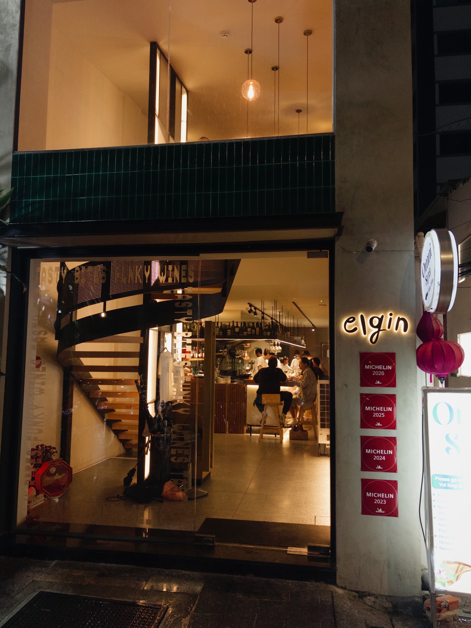 The Elgin entrance — four red Michelin plaques 2023–2026