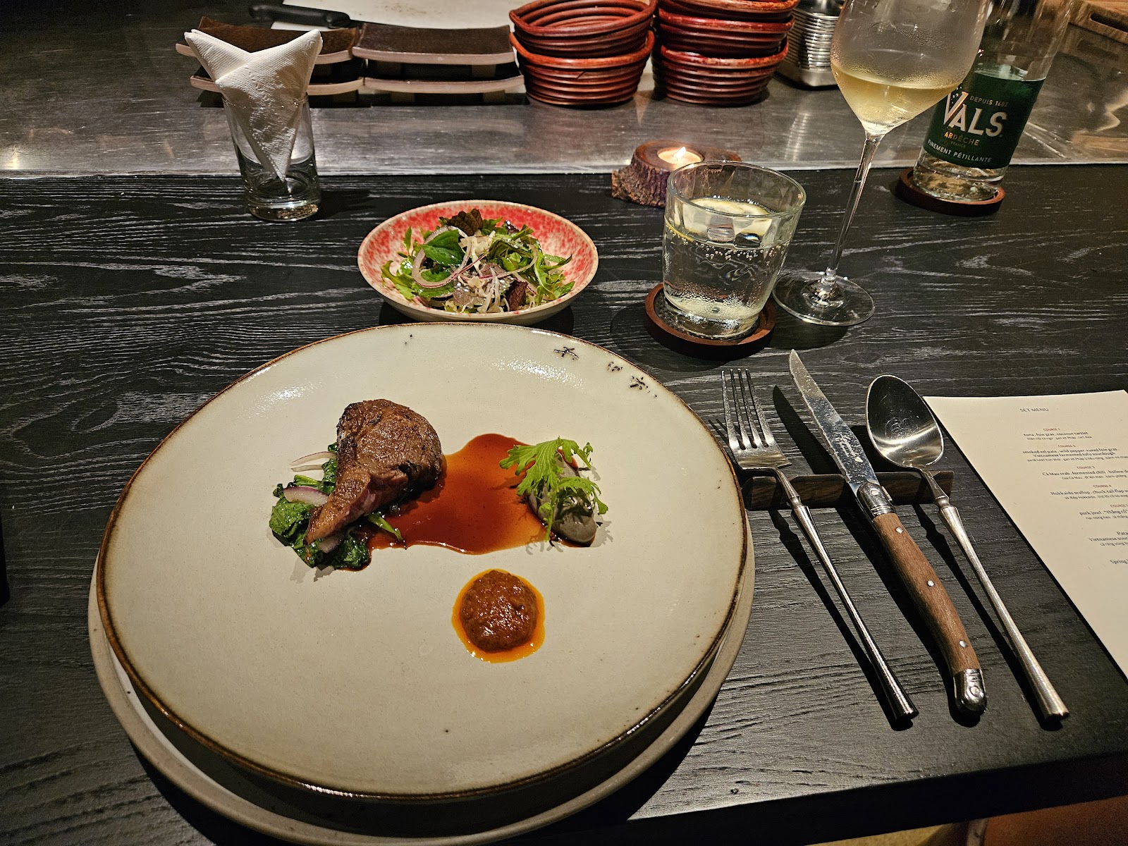 Plated roast on a set table with wine