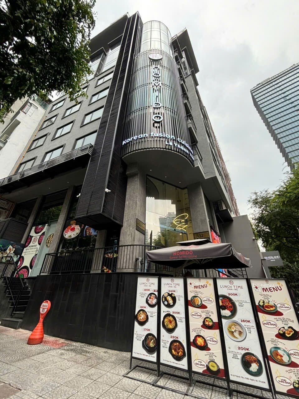 The 12 Le Thanh Ton building facade with HOMIDO signage