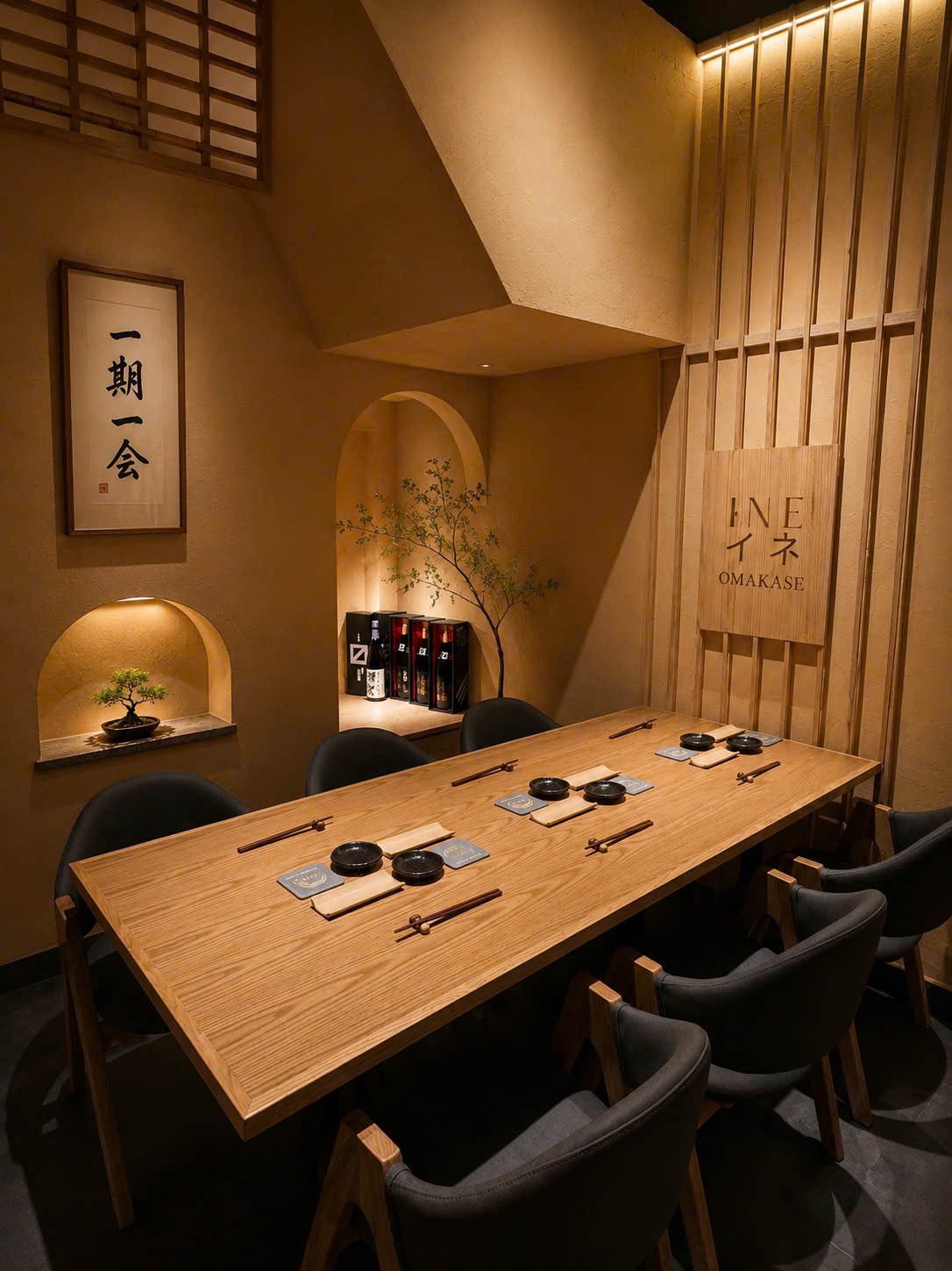 Ine’s dining room — the INE イネ OMAKASE sign, 一期一会 calligraphy, the bonsai alcove