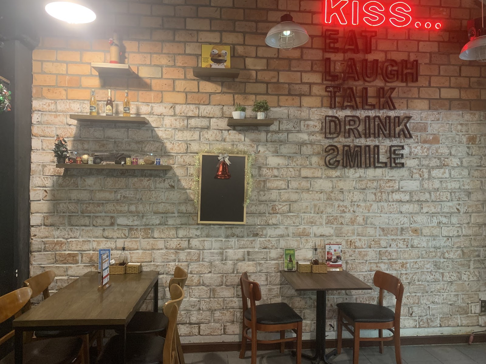 The brick wall with the red neon sign inside Italiani's