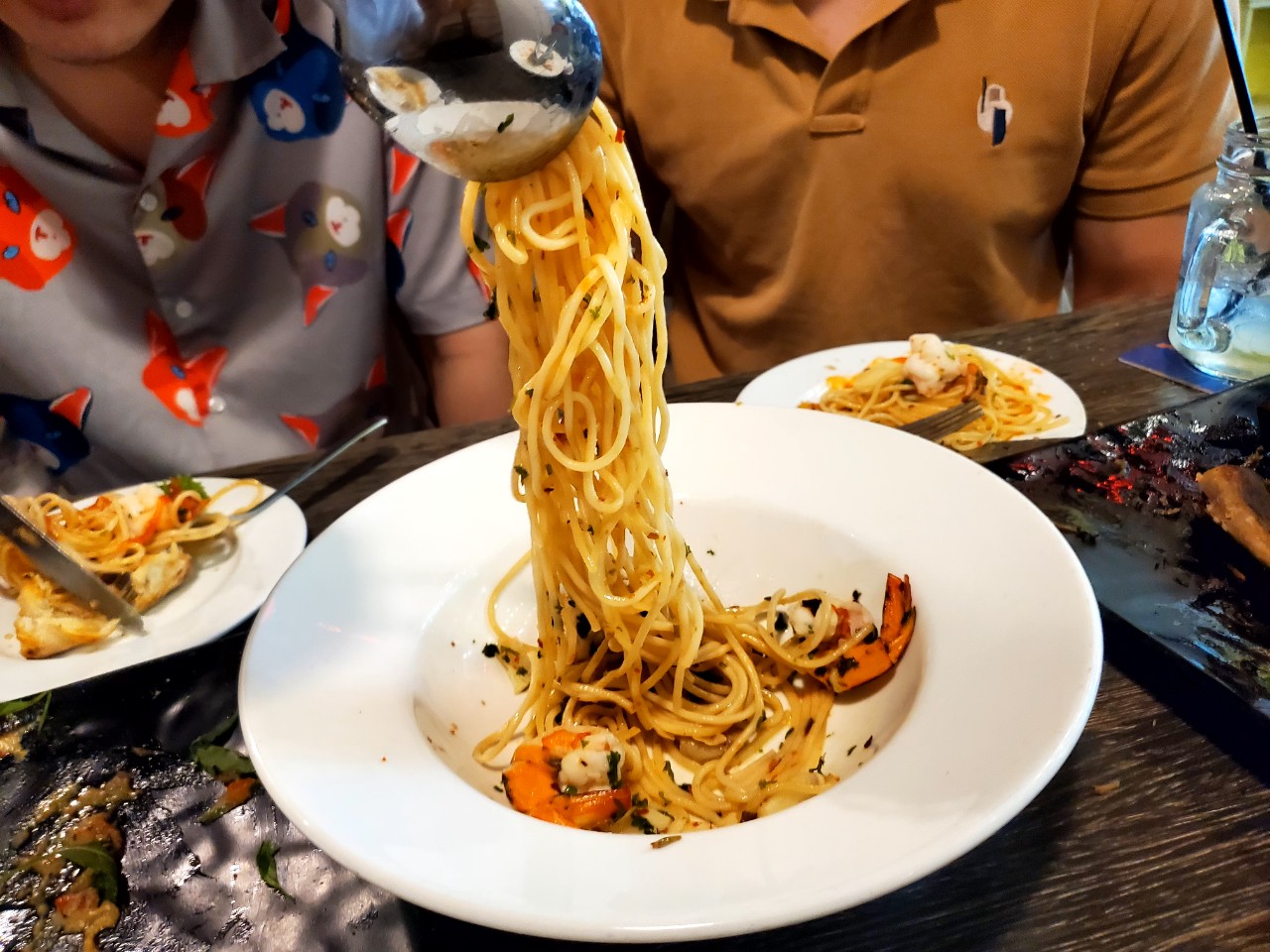 Shrimp spaghetti twirled at a crowded table