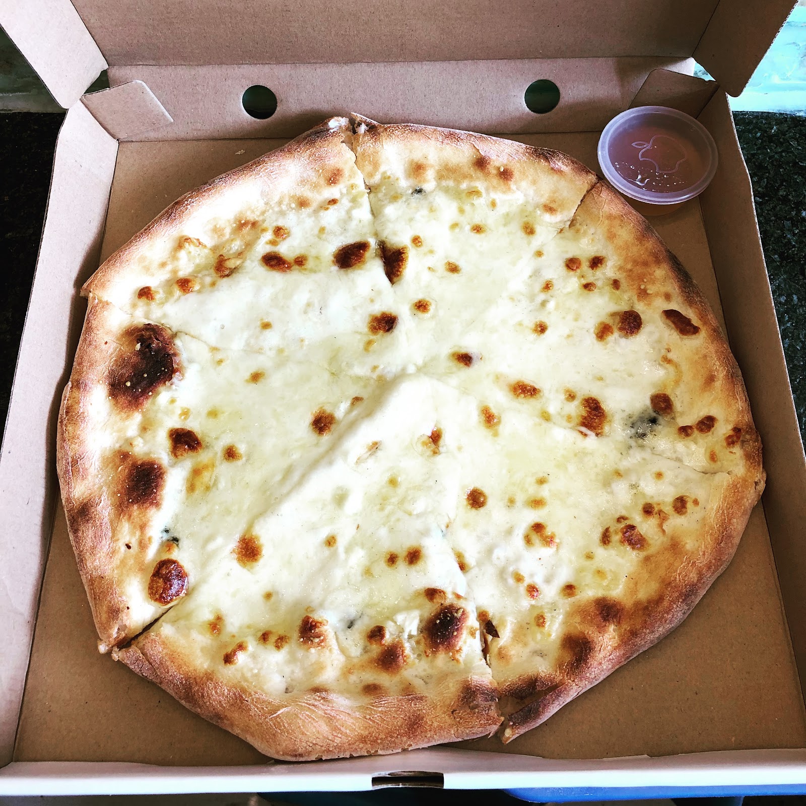 Four-cheese pizza in the box