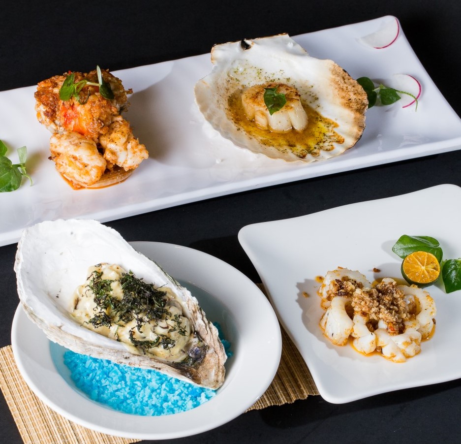 A grilled seafood spread — scallop, oyster, prawn and squid