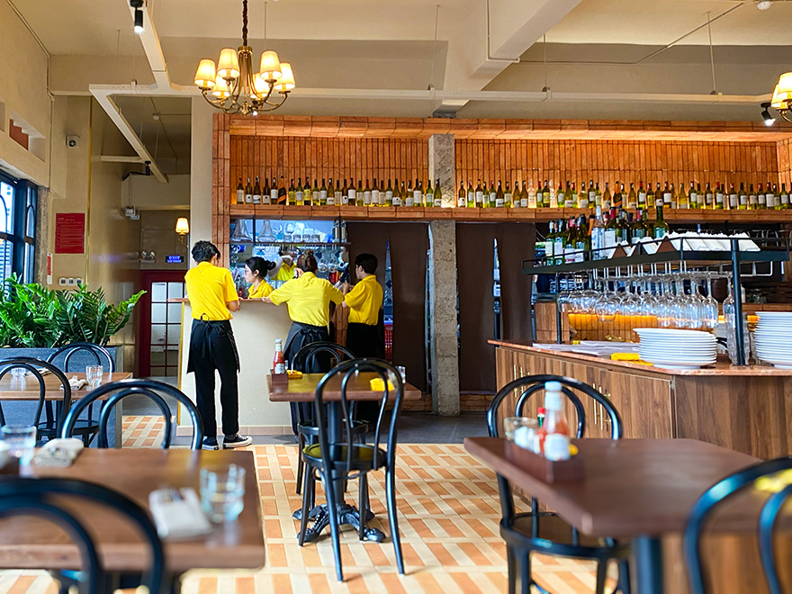 Inside: the wine wall, the bar and the service team