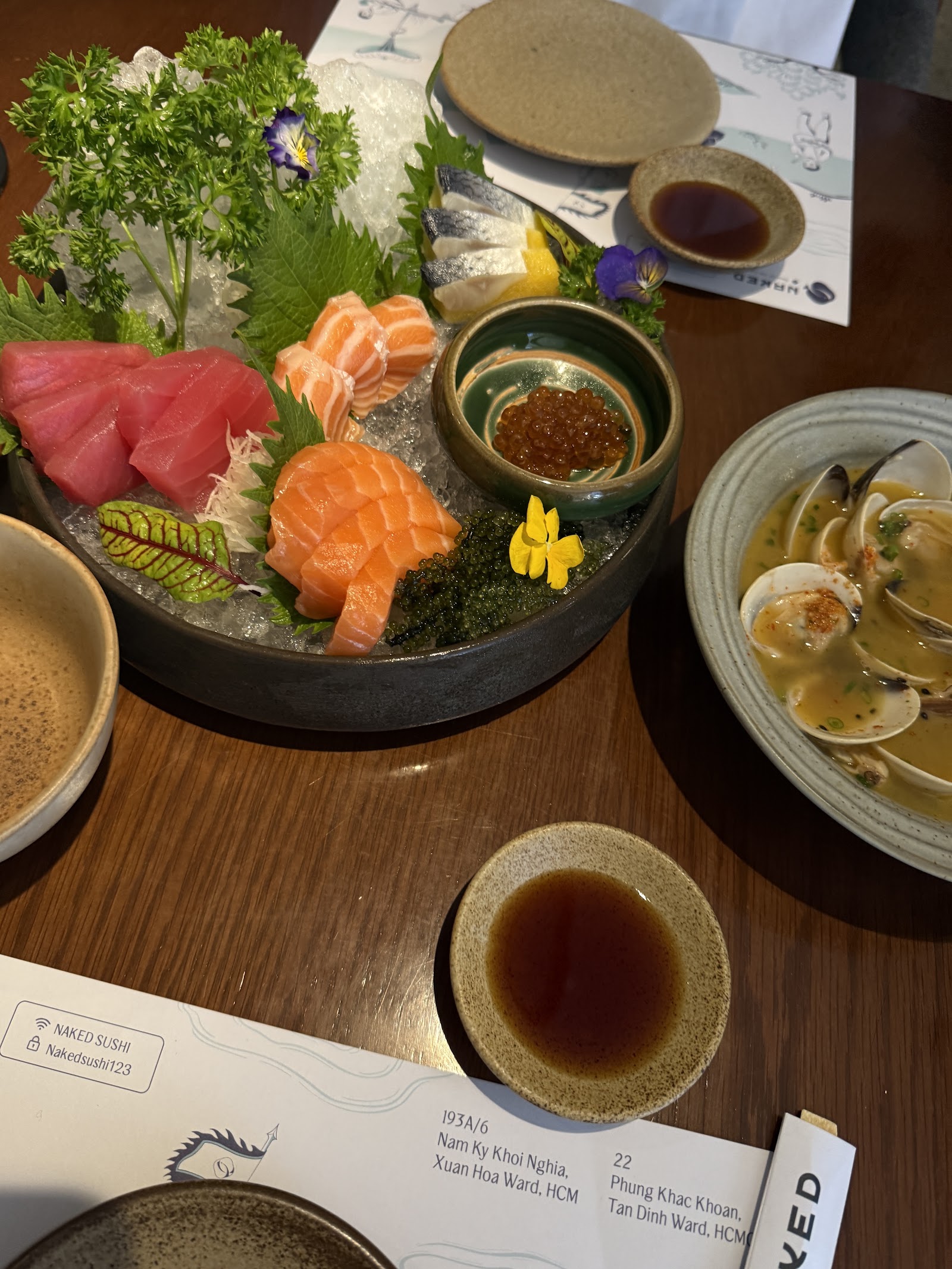 Sashimi platter over ice: tuna, salmon, mackerel, ikura, sea grapes