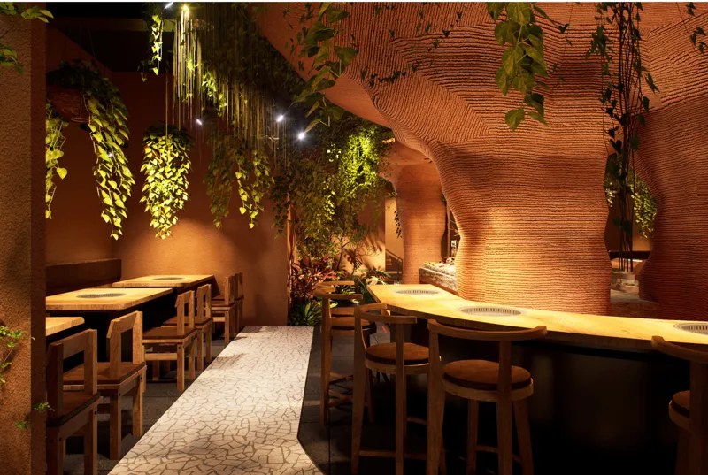 3D render of the dining hall: terracotta walls, hanging plants, grill tables