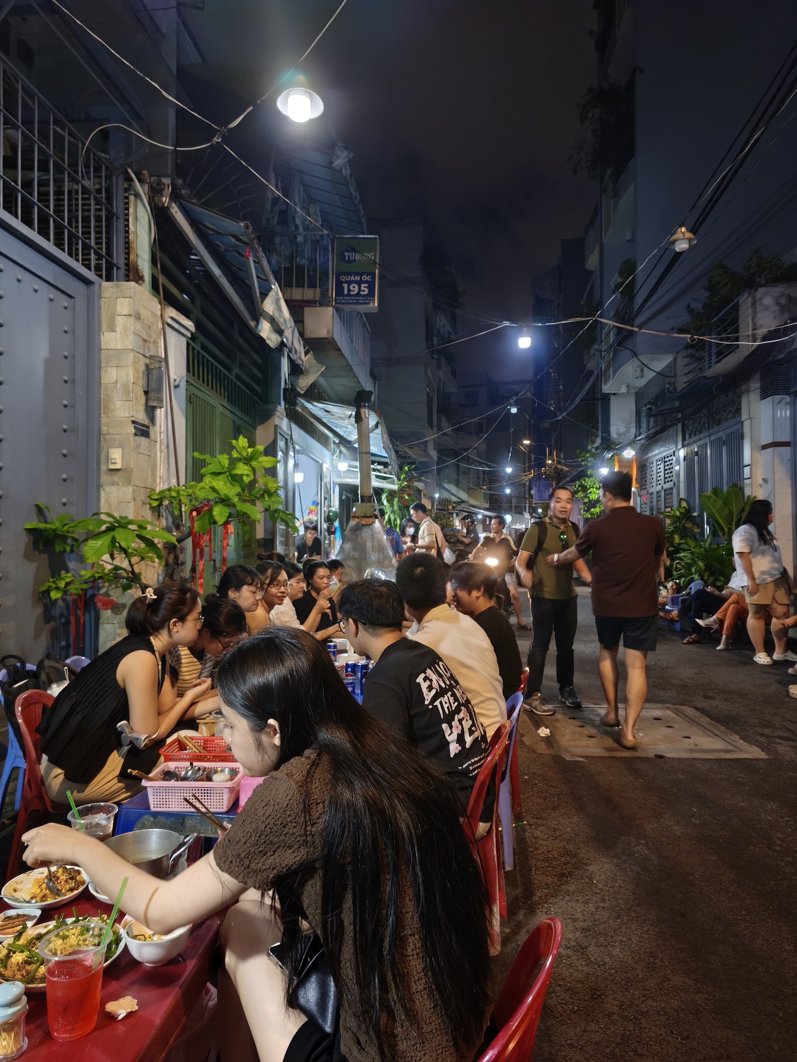 The Tran Van Dang lane at night — Oc 195 packed with tables