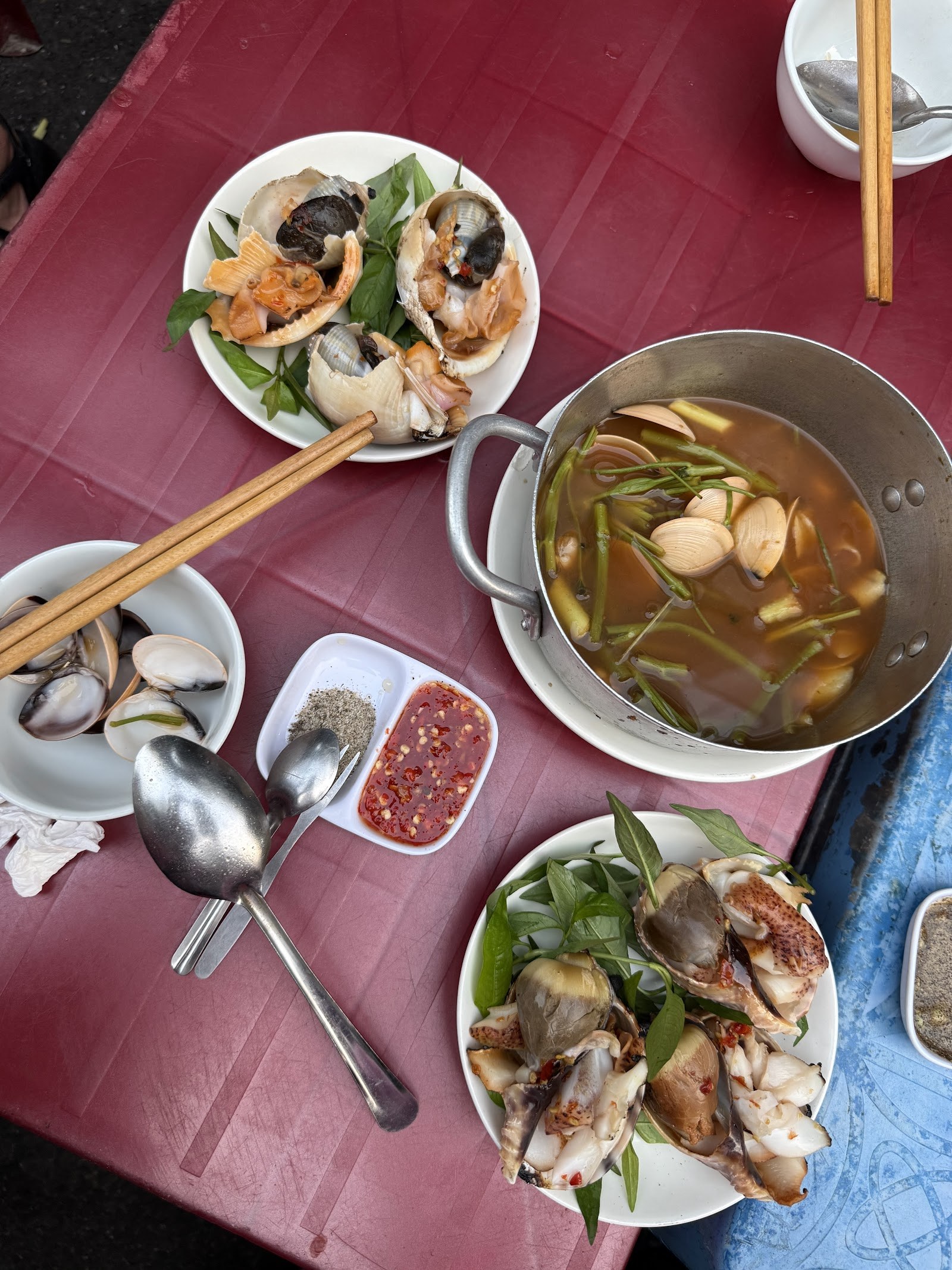 A table full of ốc dishes at the quán
