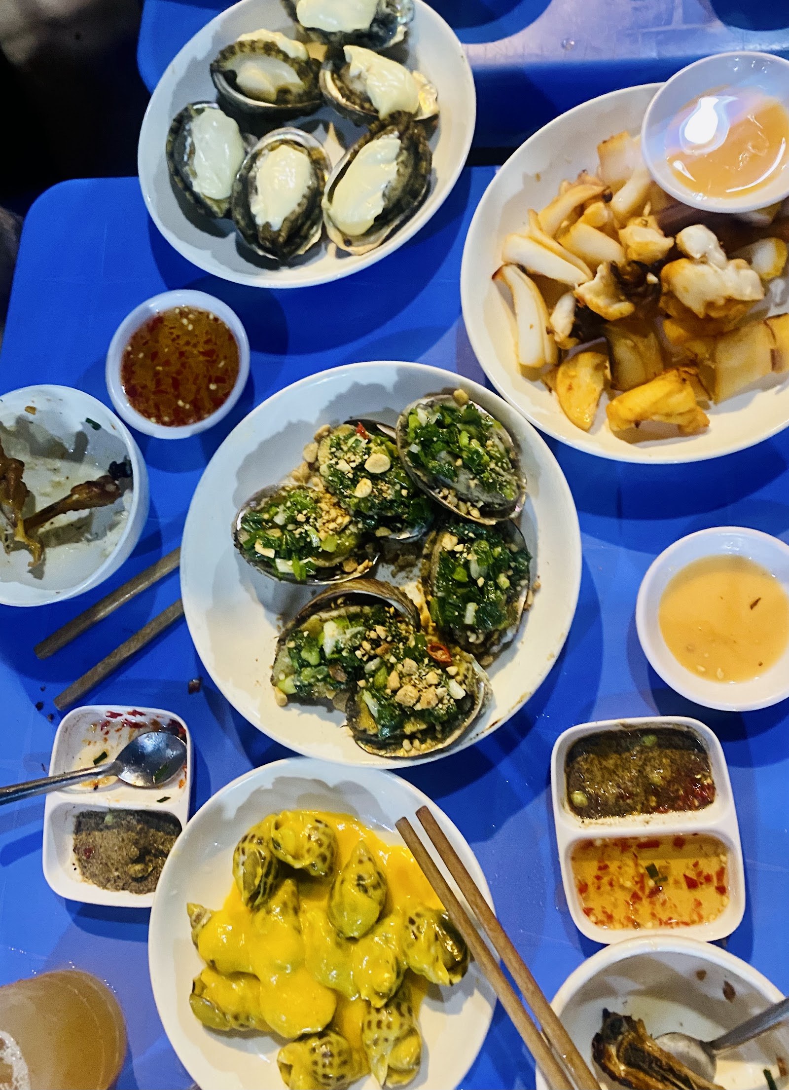 A spread of ốc dishes — clams, razor clams, fragrant snails