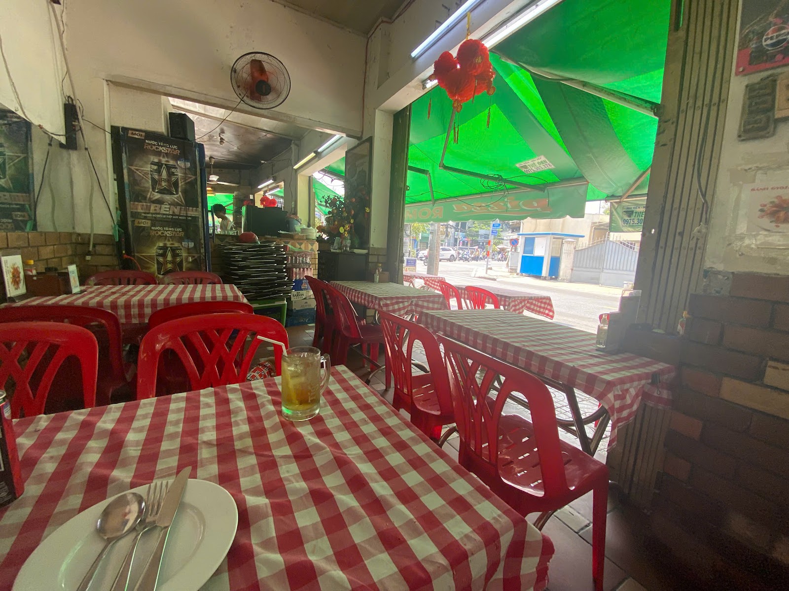 The Pizza ROMA dining room with red plastic chairs and checkered cloths