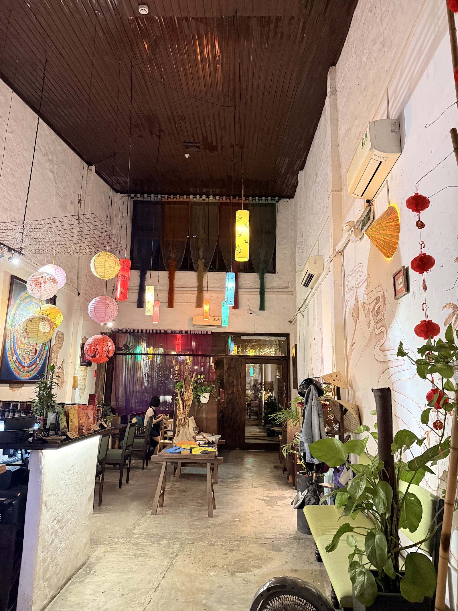Shamballa's lounge in lantern light — thangka art on the walls, high ceiling