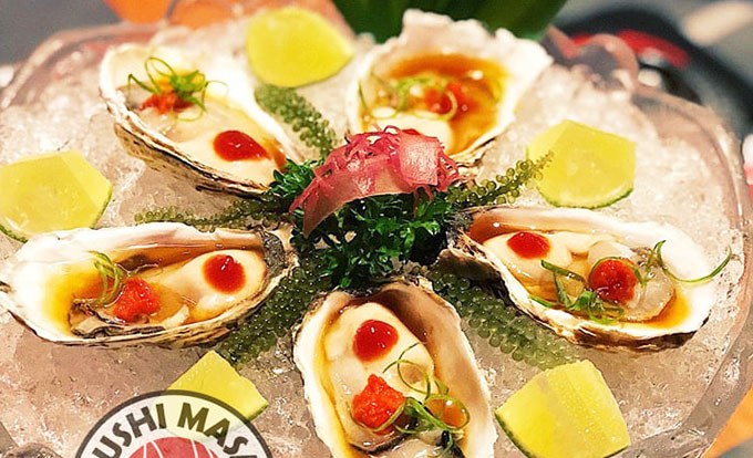 Fresh oysters on ice with ikura