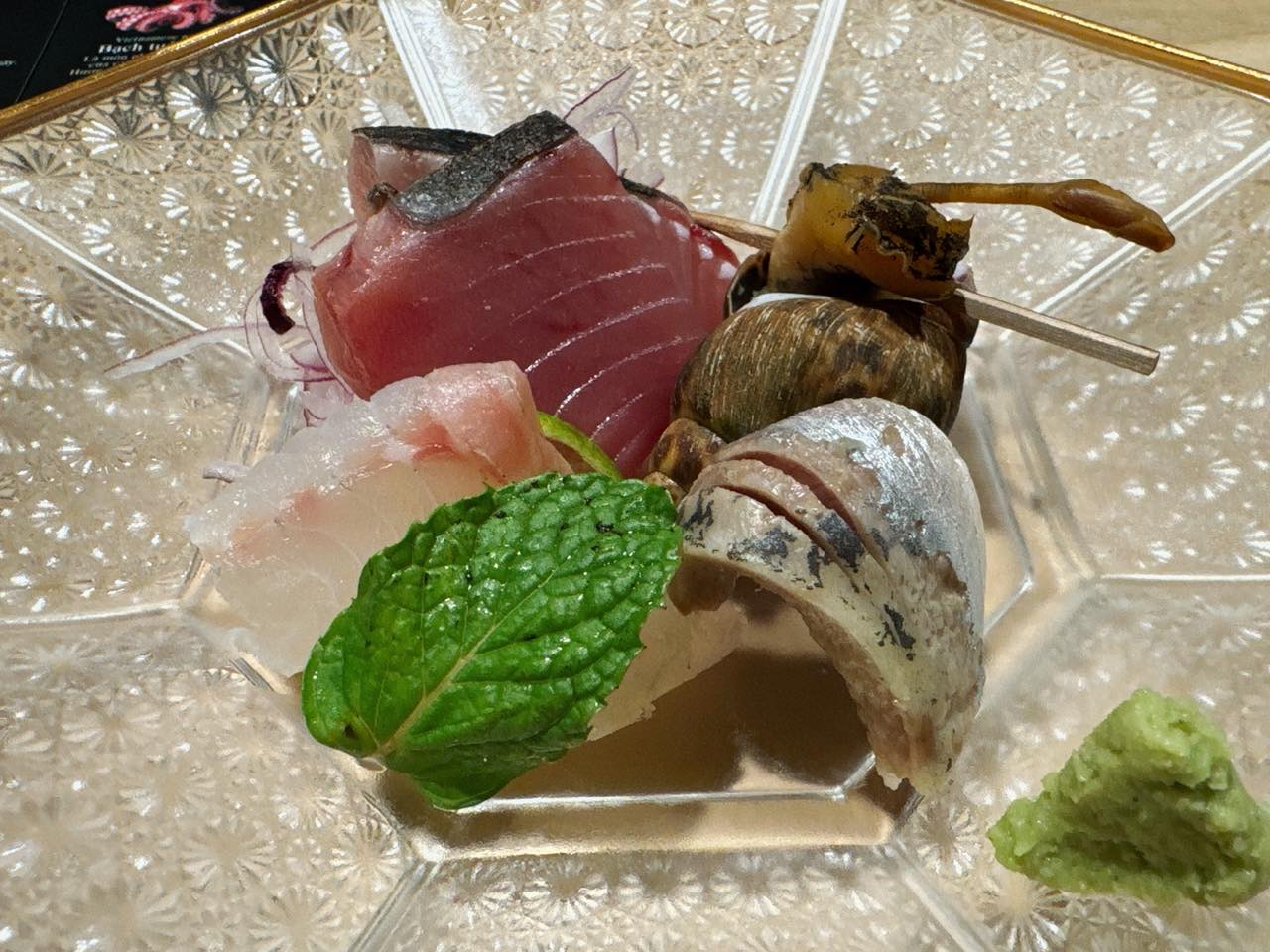 A sashimi platter: seared bonito, whitefish, shellfish, shiso and fresh wasabi