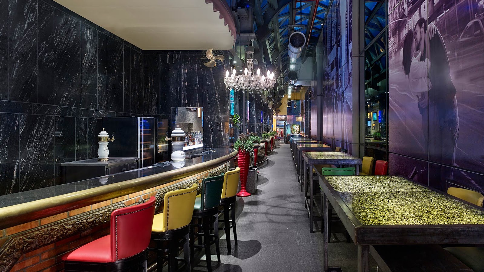 The bar hall with chandeliers and colourful bar stools