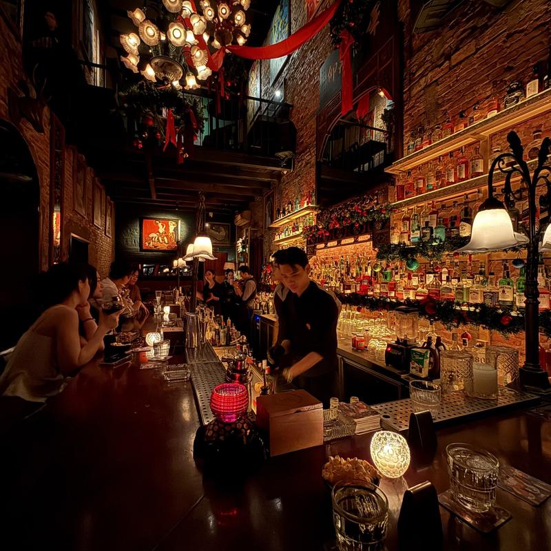 Along the bar counter with the bottle wall