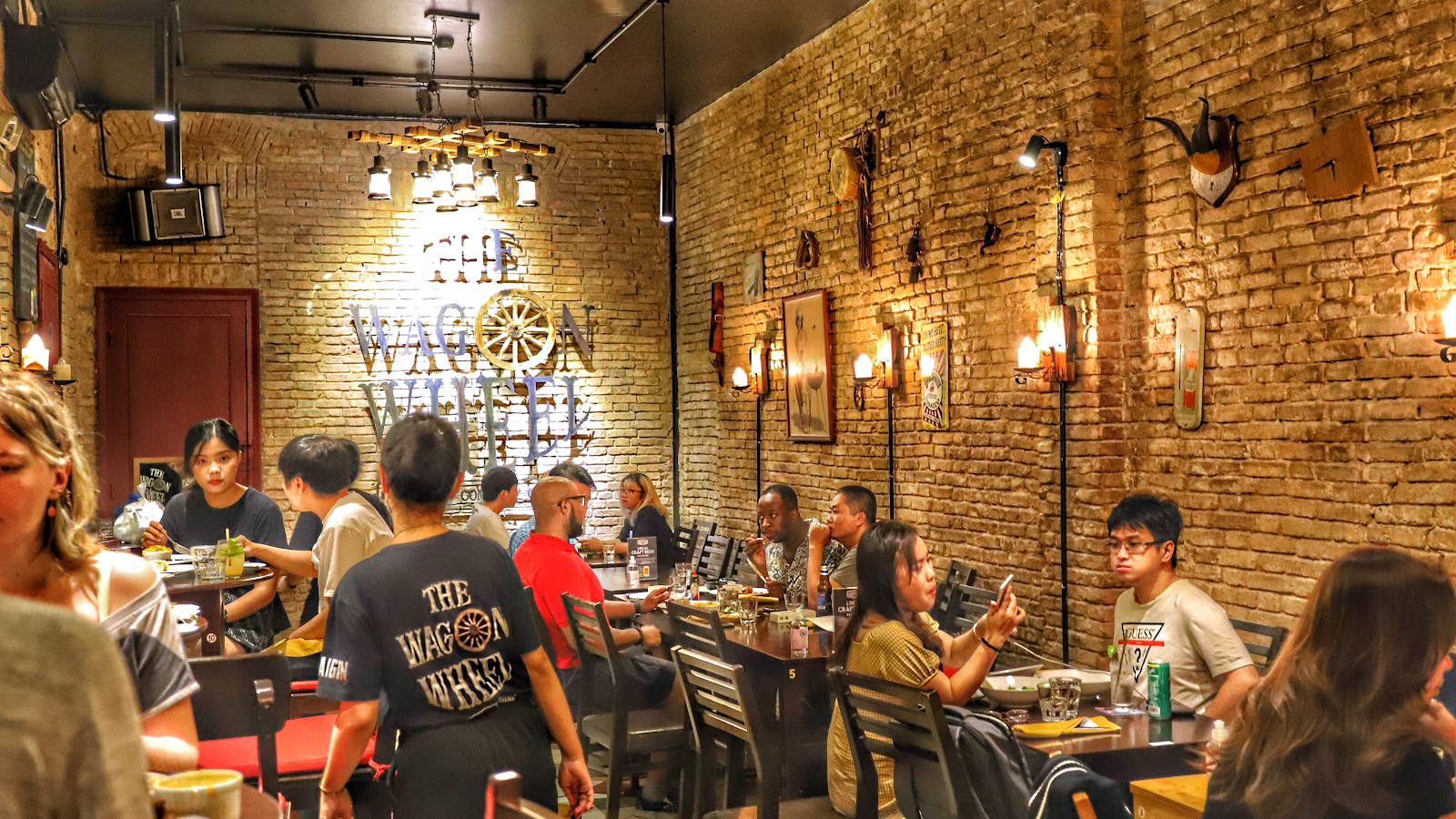 The brick room at The Wagon Wheel — the wooden wheel on the wall