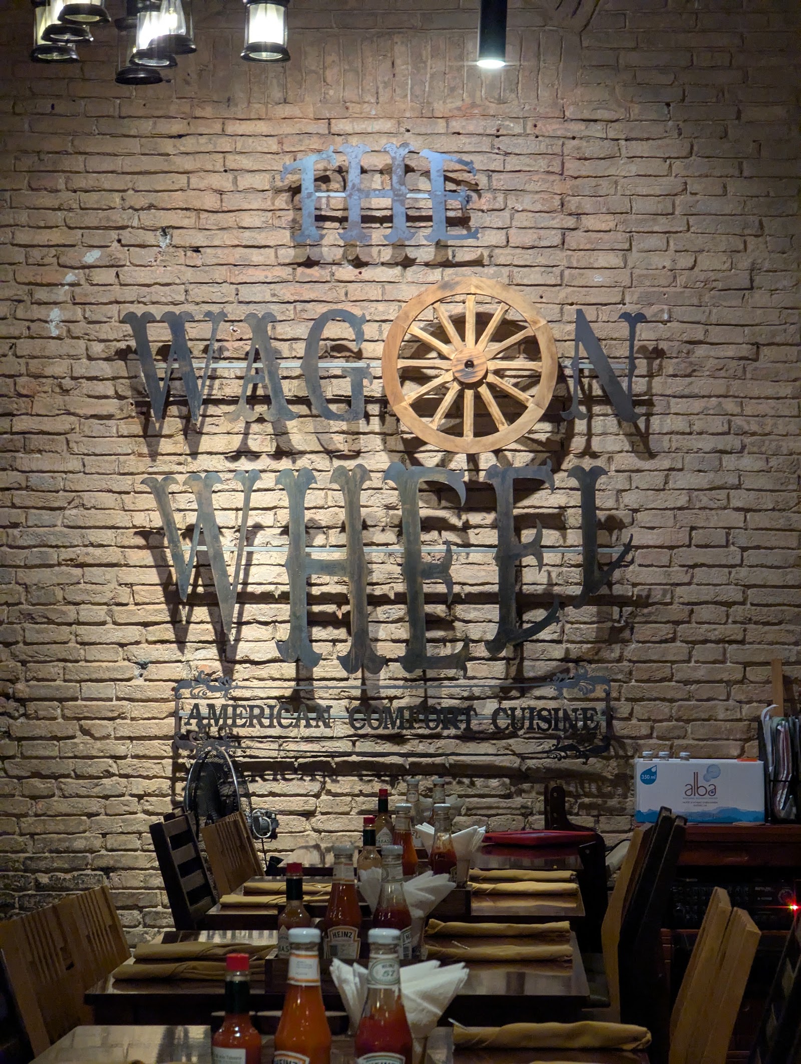 The Wagon Wheel's wooden-wheel sign on the brick wall