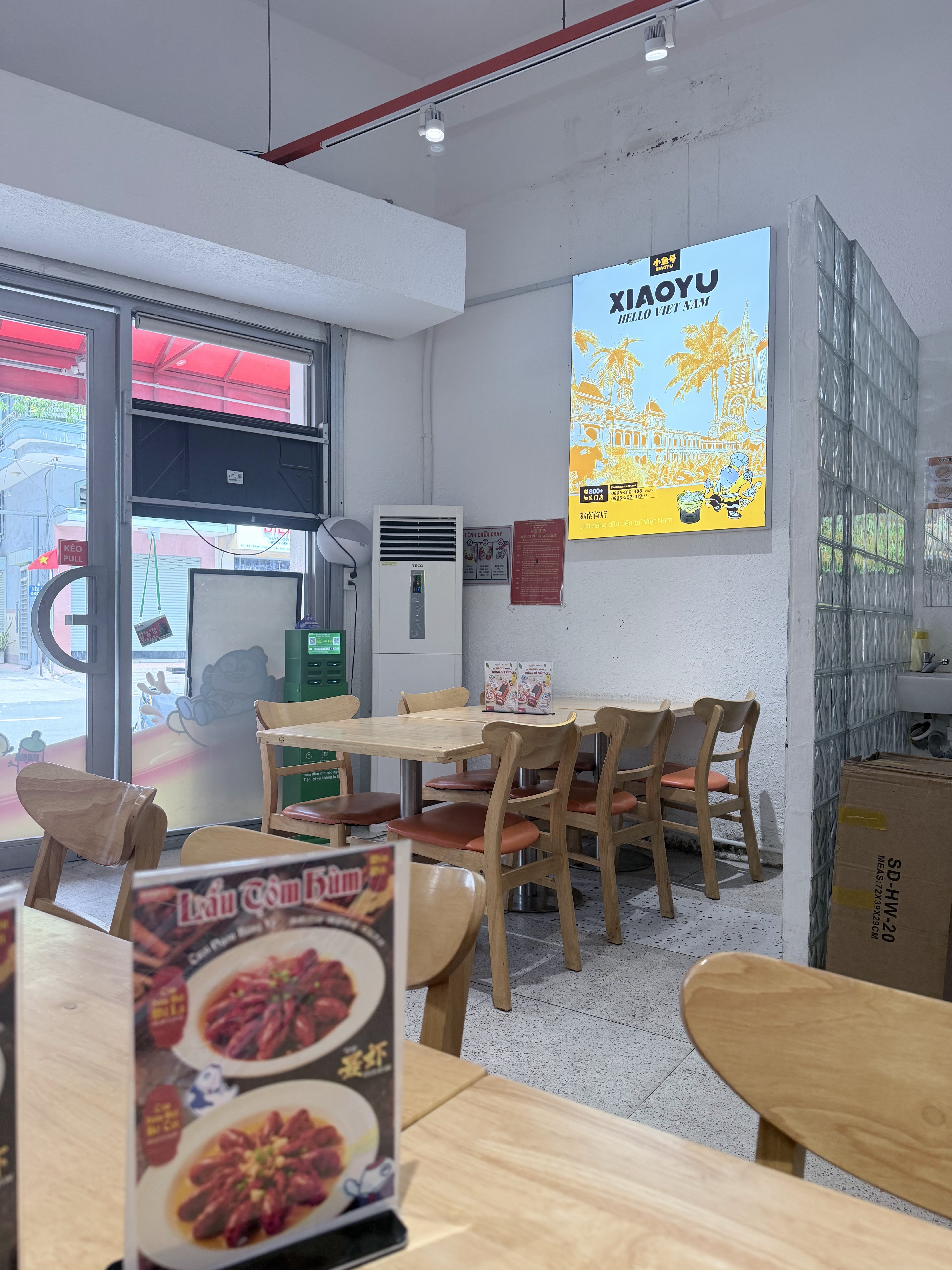 Inside XIAOYU — wooden tables under warm light