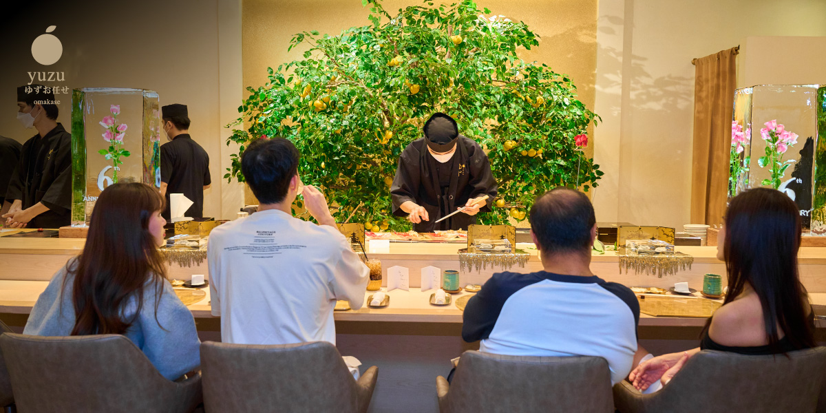 The chef behind the wooden counter with the yuzu tree